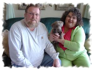 My Humans..... Holding a Light Silver Labrador Puppy